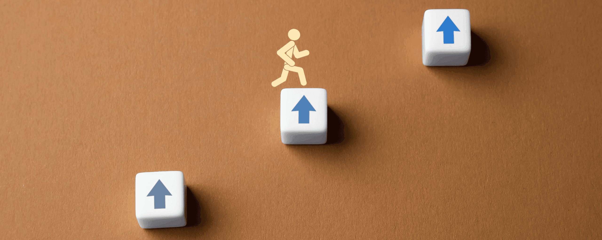 Three levels of blocks with person jumping up them.